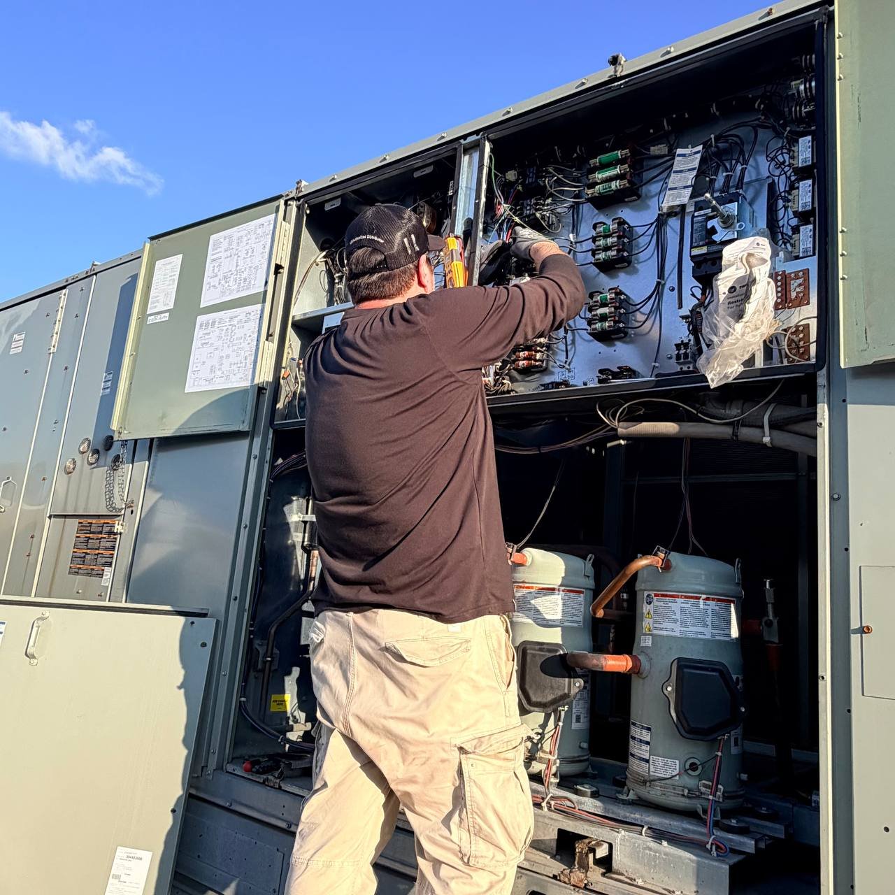 commercial HVAC McKinney TX – TechBridge Pacific technicians on rooftop unit